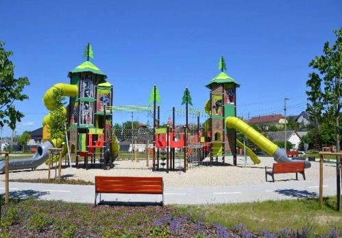 Themed children's playground with towers, slides, and outdoor play equipment.